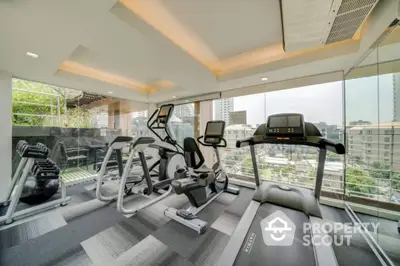 Modern gym with city view and state-of-the-art fitness equipment