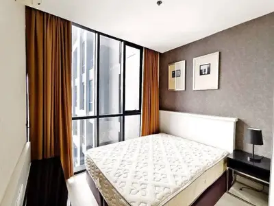 Modern bedroom with large window and stylish decor in urban apartment