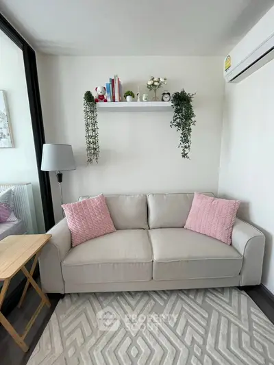 Cozy living room with modern decor and plush sofa in bright apartment.