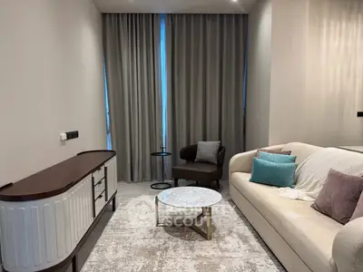 Modern living room with elegant furniture and stylish decor, featuring a cozy sofa and chic coffee table.