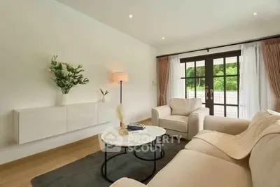 Elegant living room with cozy sofas and large windows offering natural light.