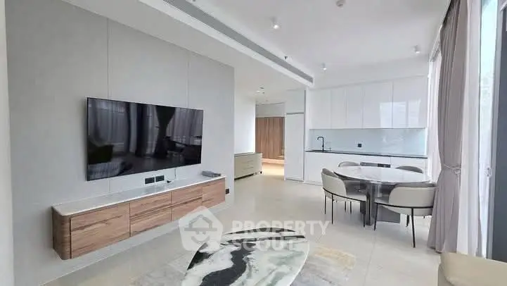 Modern open-plan living room with sleek kitchen and stylish decor