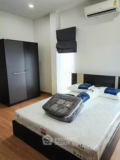 Modern bedroom with sleek furniture and air conditioning, perfect for comfort and relaxation.