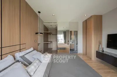 Modern bedroom with sleek design and wooden accents, featuring a cozy bed and stylish decor.
