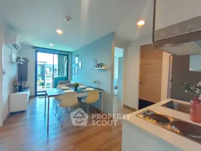 Modern open-layout living and dining area with stylish decor and natural light.