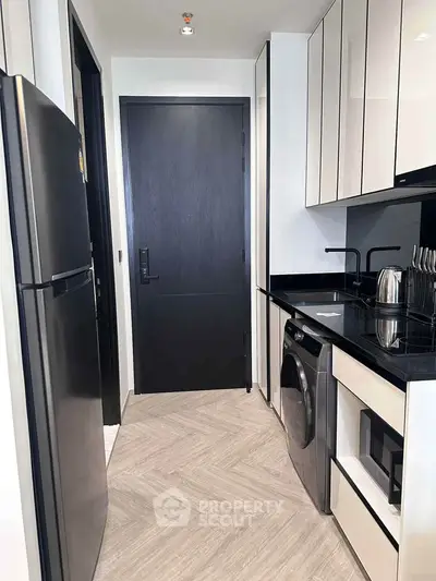 Modern kitchen with sleek black appliances and minimalist design