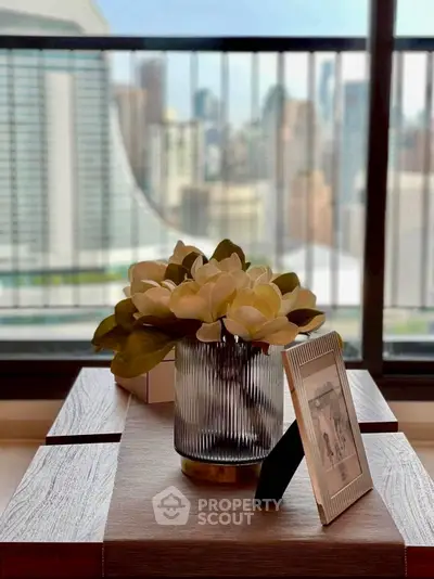 Stylish interior with elegant decor and city view from balcony, perfect for urban living.