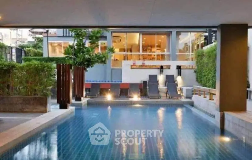 Luxurious modern pool area with stylish lounge chairs and ambient lighting