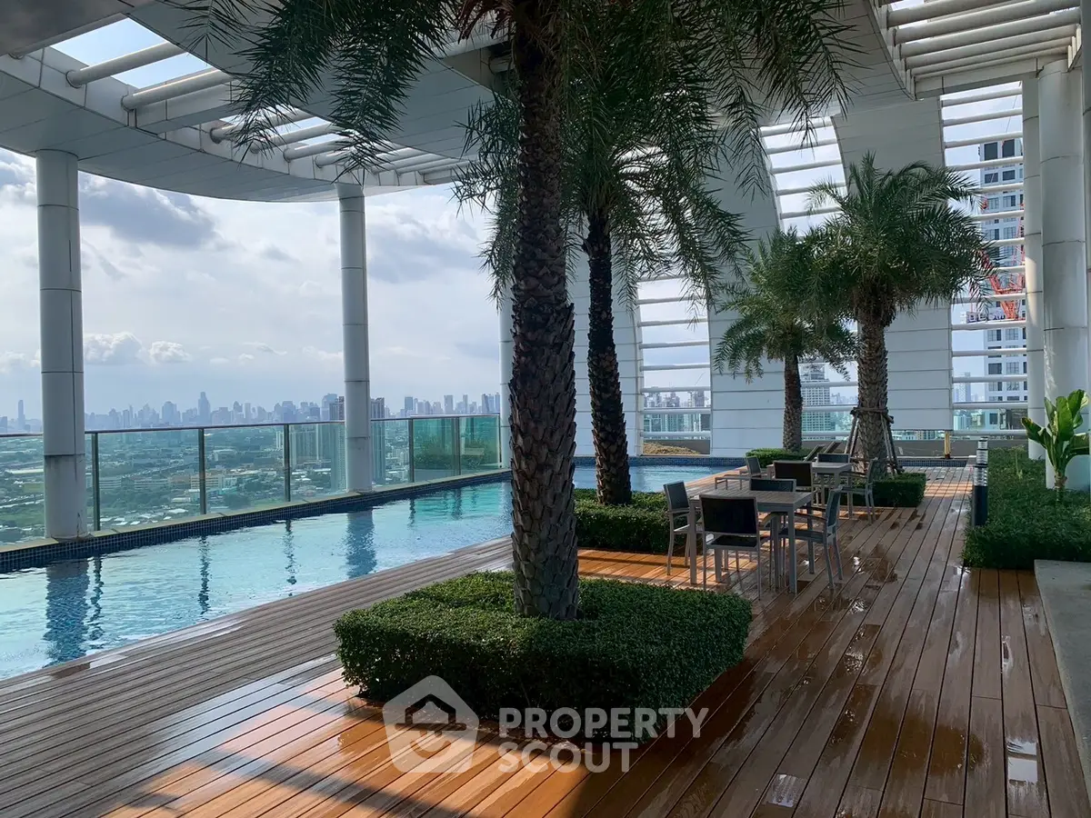Luxurious rooftop pool with stunning city skyline views and elegant seating area.