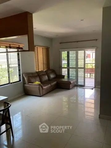 Spacious living room with large windows and modern furniture