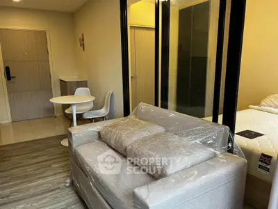 Modern studio apartment with cozy living area and stylish furniture