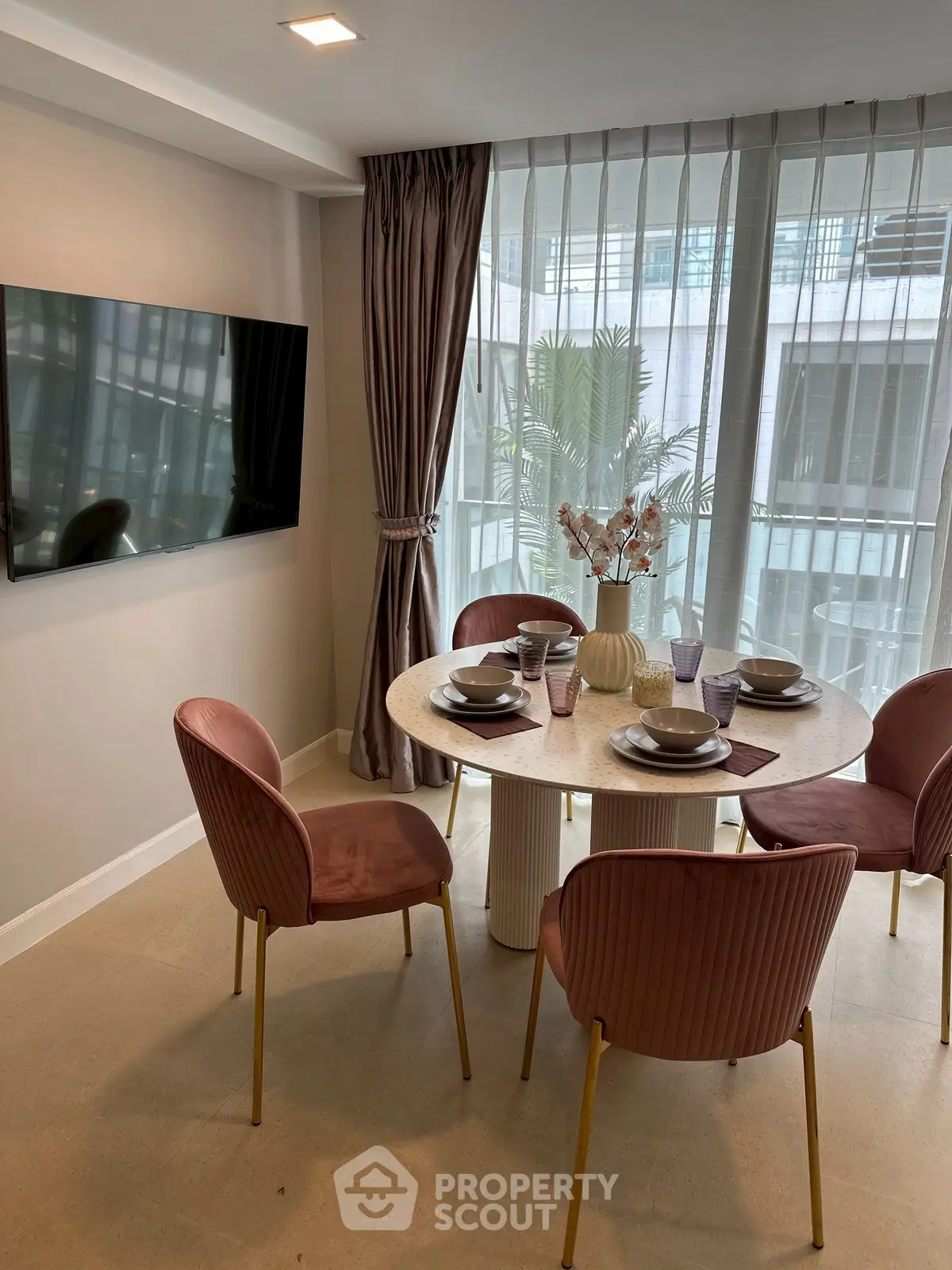 Elegant dining area with modern decor and large window view