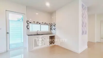 Modern kitchen with sleek design and geometric backsplash in a bright, spacious home.
