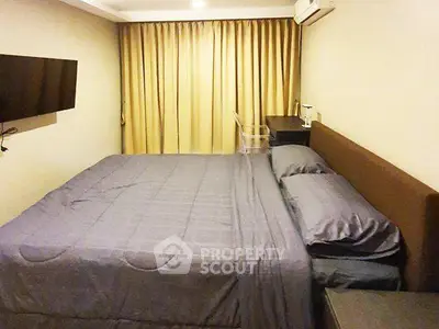 Cozy bedroom with modern furnishings and ambient lighting, perfect for relaxation and comfort.