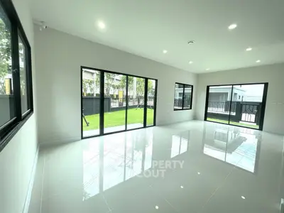 Spacious modern living room with large windows and garden view