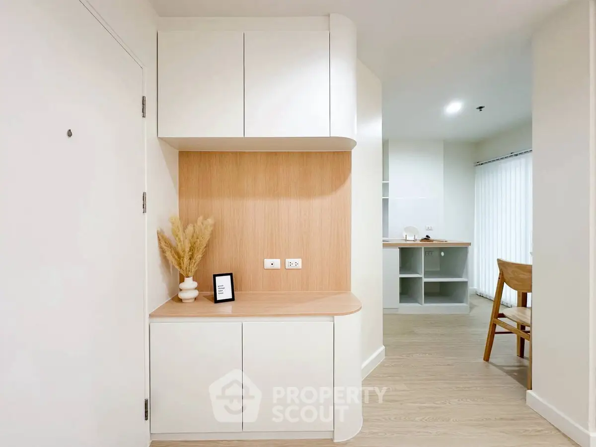 Modern minimalist interior with light wood accents and sleek cabinetry