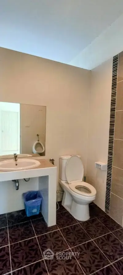 Modern bathroom with sleek fixtures and stylish tile flooring, perfect for a contemporary home.