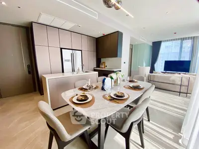 Luxurious open-plan kitchen and dining area with modern decor and ample natural light.
