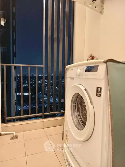 Modern apartment balcony with washing machine and stunning city night view.