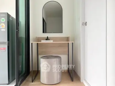 Modern compact study nook with mirror and stool in a stylish apartment.
