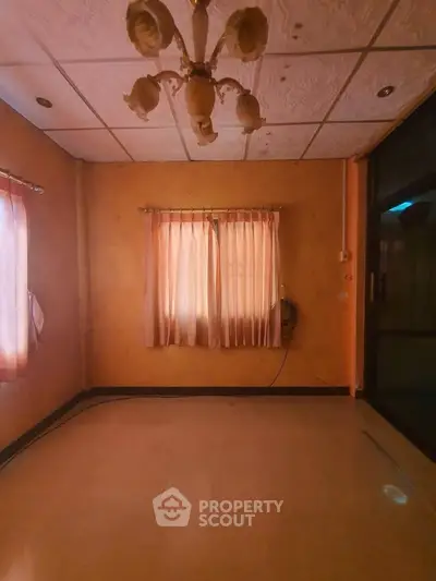 Cozy room with warm lighting and elegant ceiling fixture, perfect for a tranquil living space.
