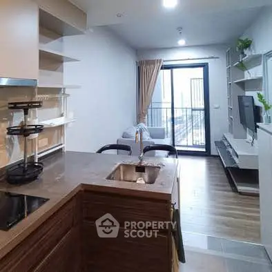 Modern open-layout kitchen and living room with balcony view