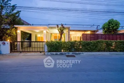 Charming single-story home with modern design and lush greenery, perfect for serene living.