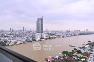 Stunning cityscape view from high-rise building overlooking river and skyline.