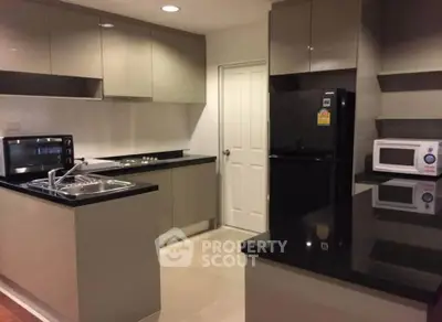 Modern kitchen with sleek black countertops and stainless steel appliances