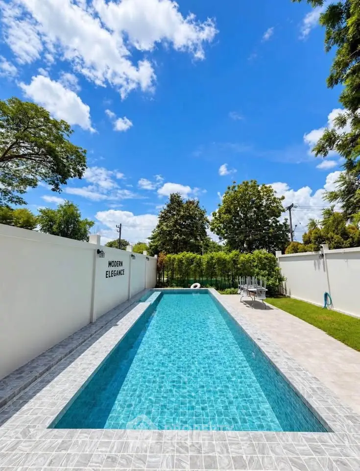 Luxurious private pool with modern elegance under a clear blue sky, perfect for relaxation and leisure.