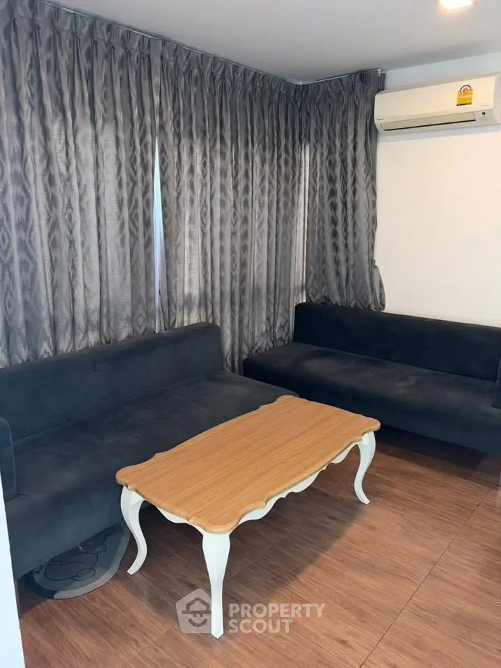 Cozy living room with elegant wooden table and plush sofas, perfect for relaxation.