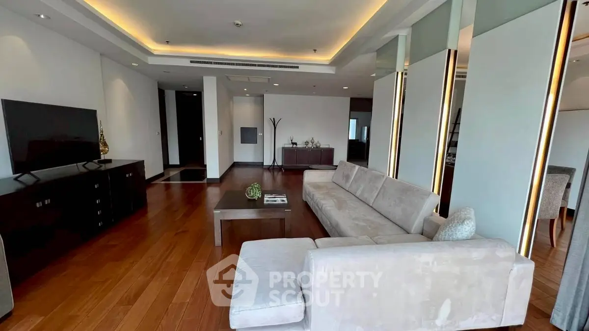 Spacious modern living room with elegant lighting and sleek furniture