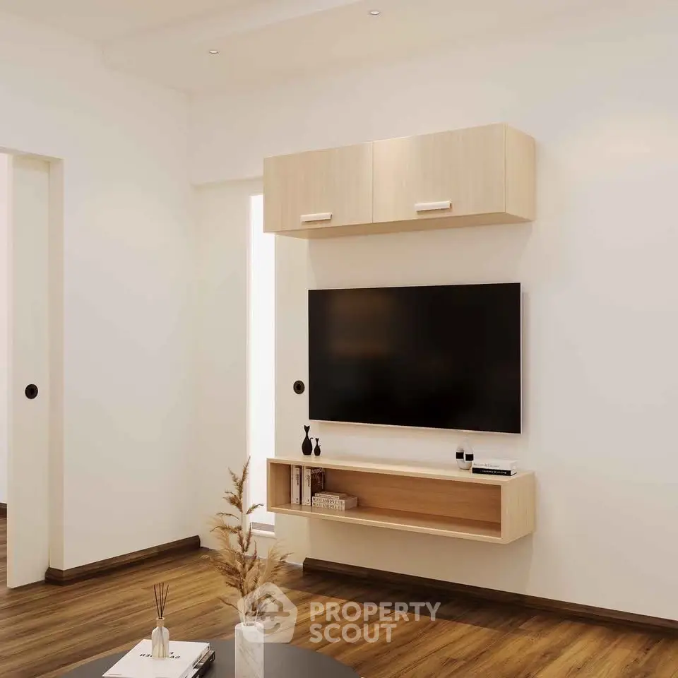 Modern living room with sleek TV setup and wooden flooring, perfect for contemporary living.