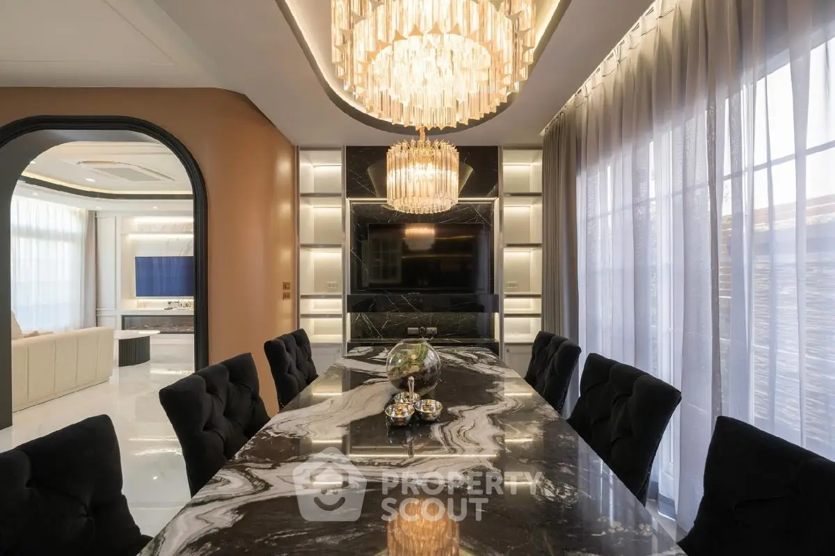 Luxurious dining room with elegant marble table and stunning chandeliers