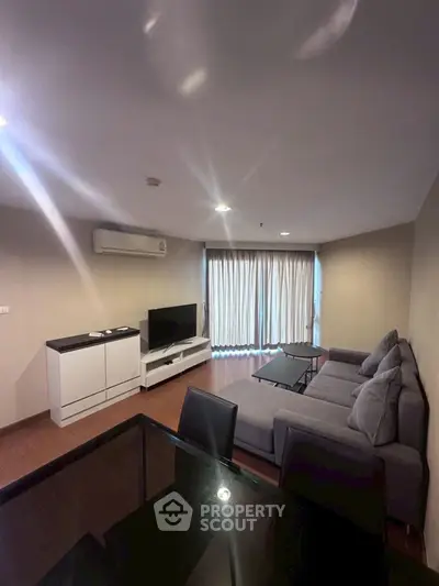 Spacious living room with modern furniture and large windows for natural light.