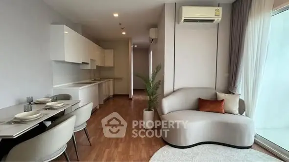 Modern living room with sleek furniture and open kitchen layout