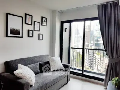Modern living room with city view and stylish decor in high-rise apartment.