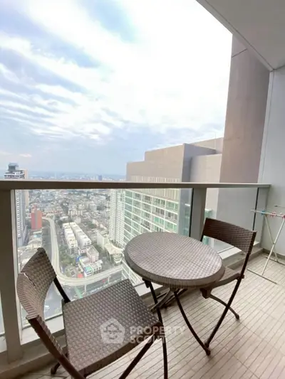 Stunning high-rise balcony with breathtaking cityscape views and cozy seating area.