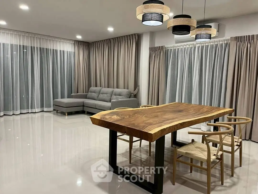 Spacious modern living room with elegant dining area and stylish lighting