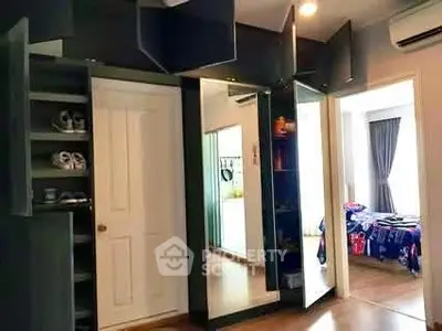 Spacious bedroom with mirrored wardrobe and modern decor