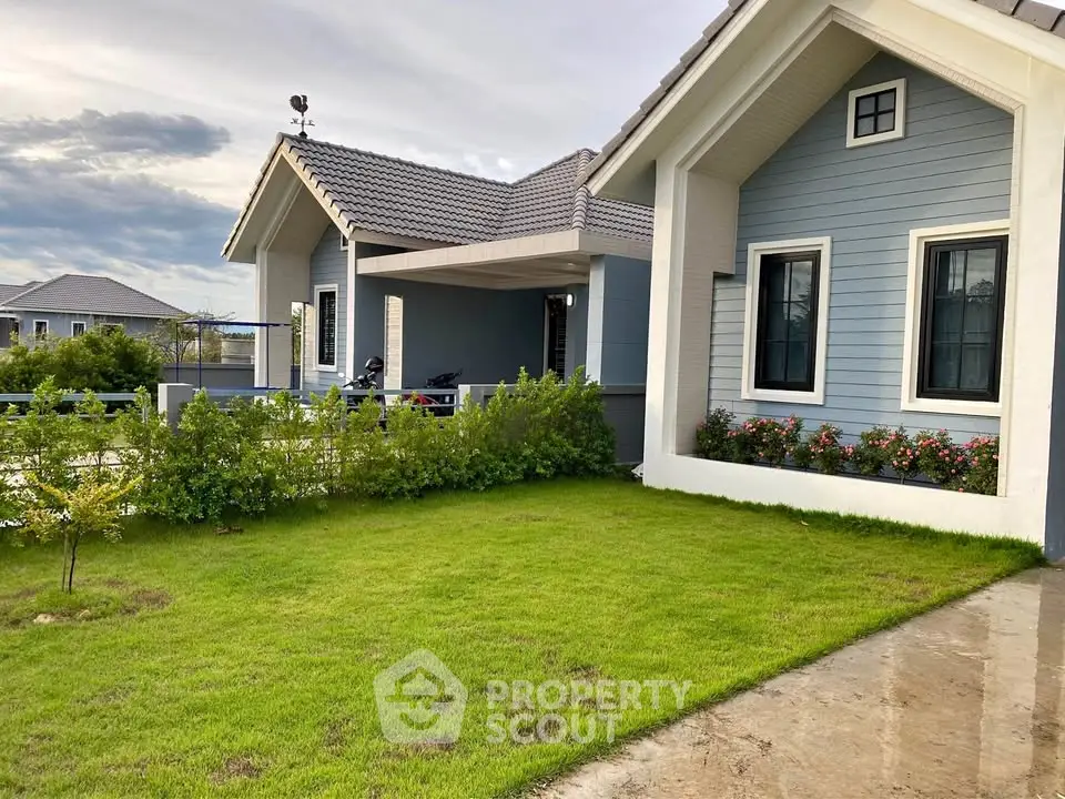 Charming suburban home with lush green lawn and modern architecture, perfect for family living.
