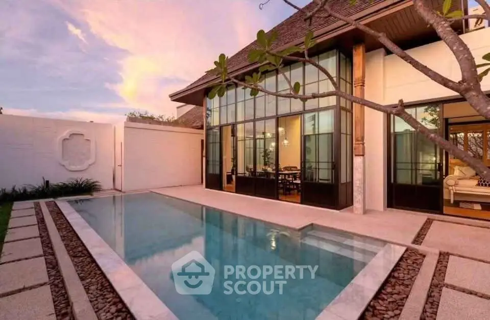 Luxurious modern villa with private pool and elegant architecture at sunset.