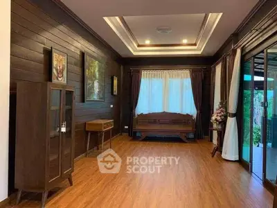 Spacious living room with wooden flooring and elegant decor in a modern home.
