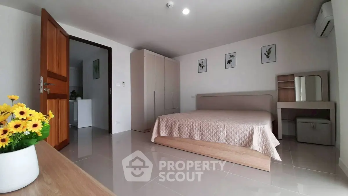 Spacious modern bedroom with elegant decor and natural light