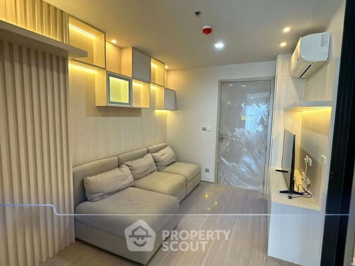 Modern living room with stylish lighting and cozy sofa in a contemporary apartment.