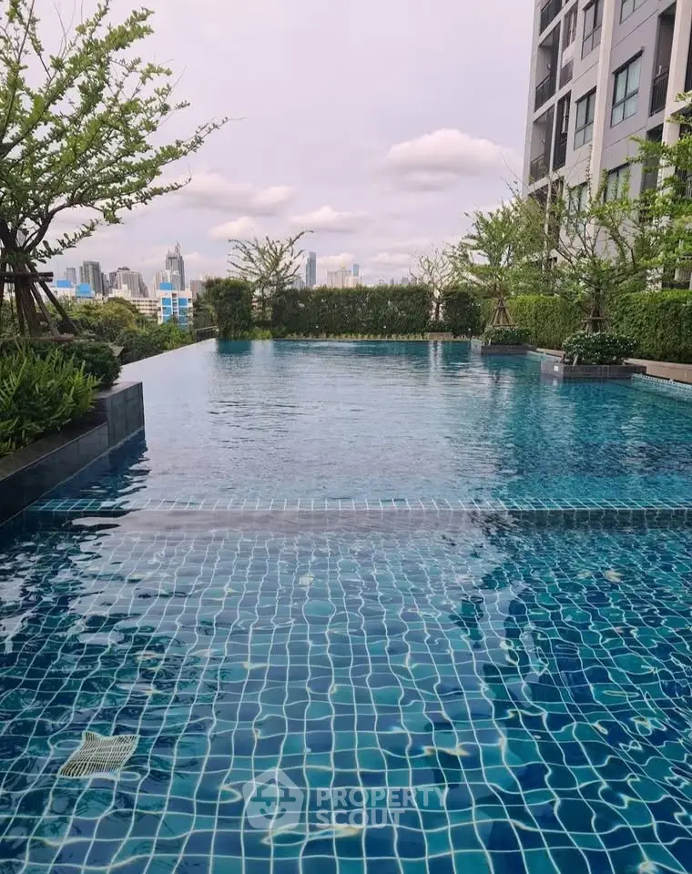 Luxurious rooftop pool with stunning city views in modern residential building.