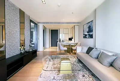 Modern living room with elegant decor and open layout, featuring a stylish sofa and contemporary artwork.