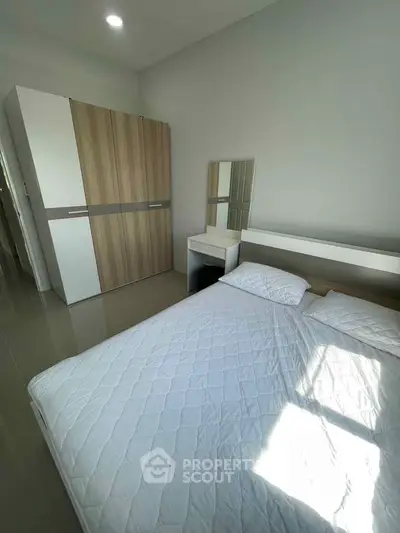 Modern bedroom with sleek wardrobe and minimalist decor