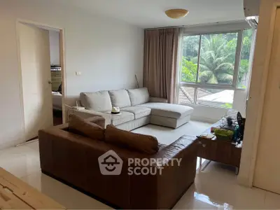 Spacious living room with modern furniture and large window view