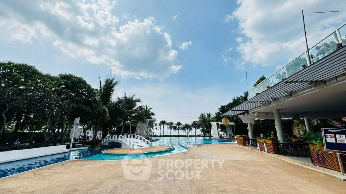 Luxurious poolside area with stunning ocean view and lush greenery, perfect for relaxation and leisure.